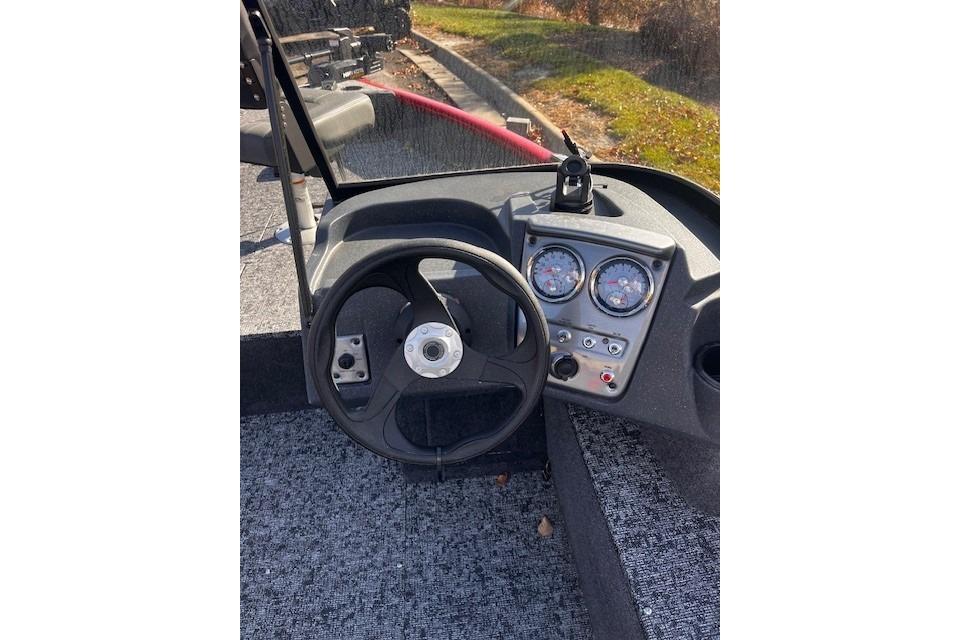 Tracker Pro Guide V-16 WT Steering console of 2026 Tracker Pro Guide V-16 WT boat with gauges and controls.