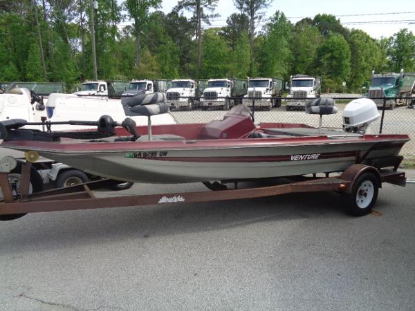 Venture Bass Boat 18 1987 Venture Bass Boat 18 on trailer in parking lot.