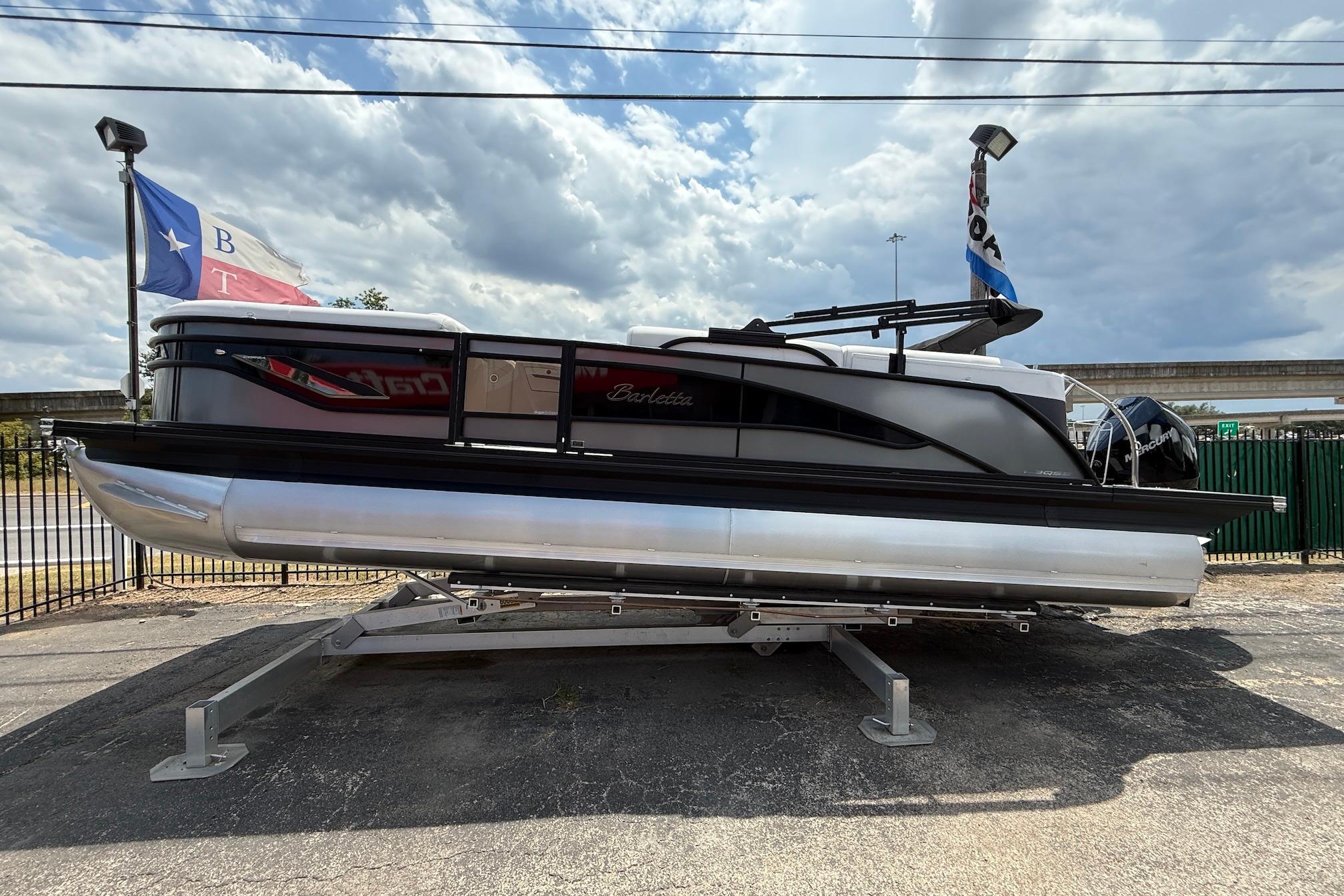 Barletta CORSA 23QSS 2024 Barletta CORSA 23QSS pontoon boat on display under cloudy sky.
