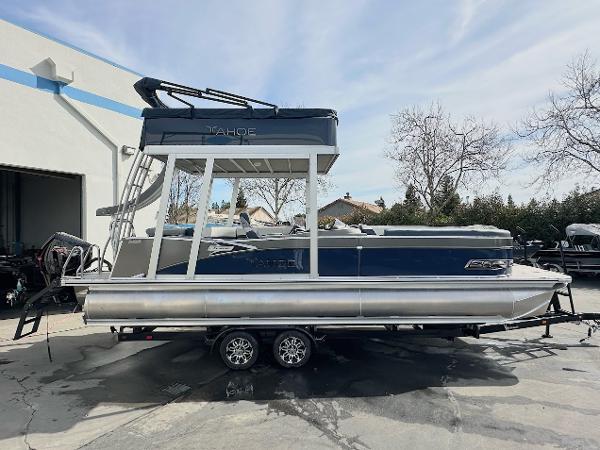 Tahoe Pontoon Cascade Cruise Funship 2025 Tahoe Pontoon Cascade Cruise Funship, blue and silver, parked on a trailer outdoors.