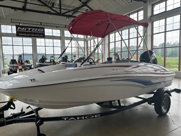 Tahoe T16 2024 Tahoe T16 boat with red canopy on display in showroom.