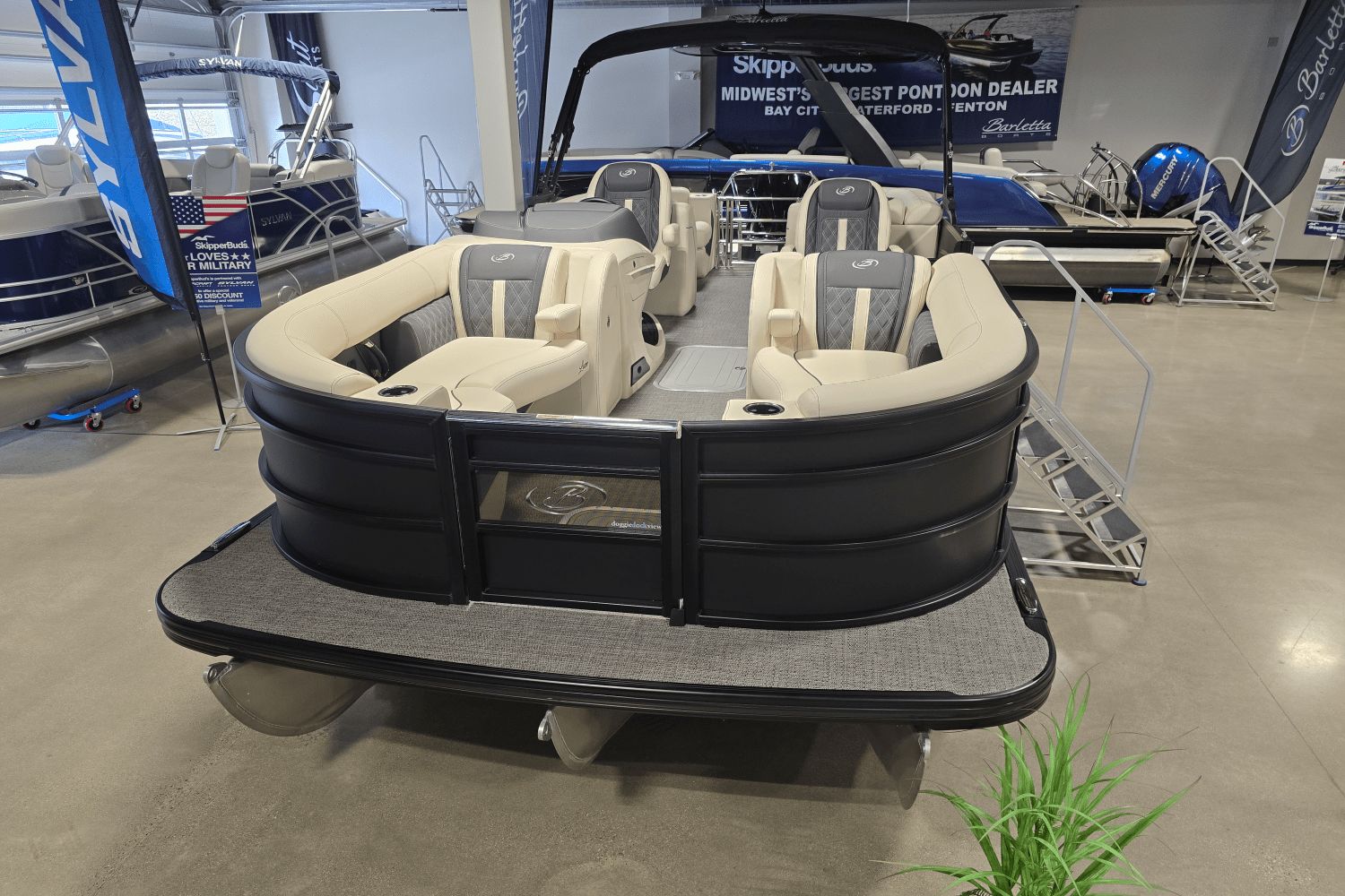 Barletta lusso 2025 Barletta Lusso pontoon boat displayed in showroom with luxurious seating.