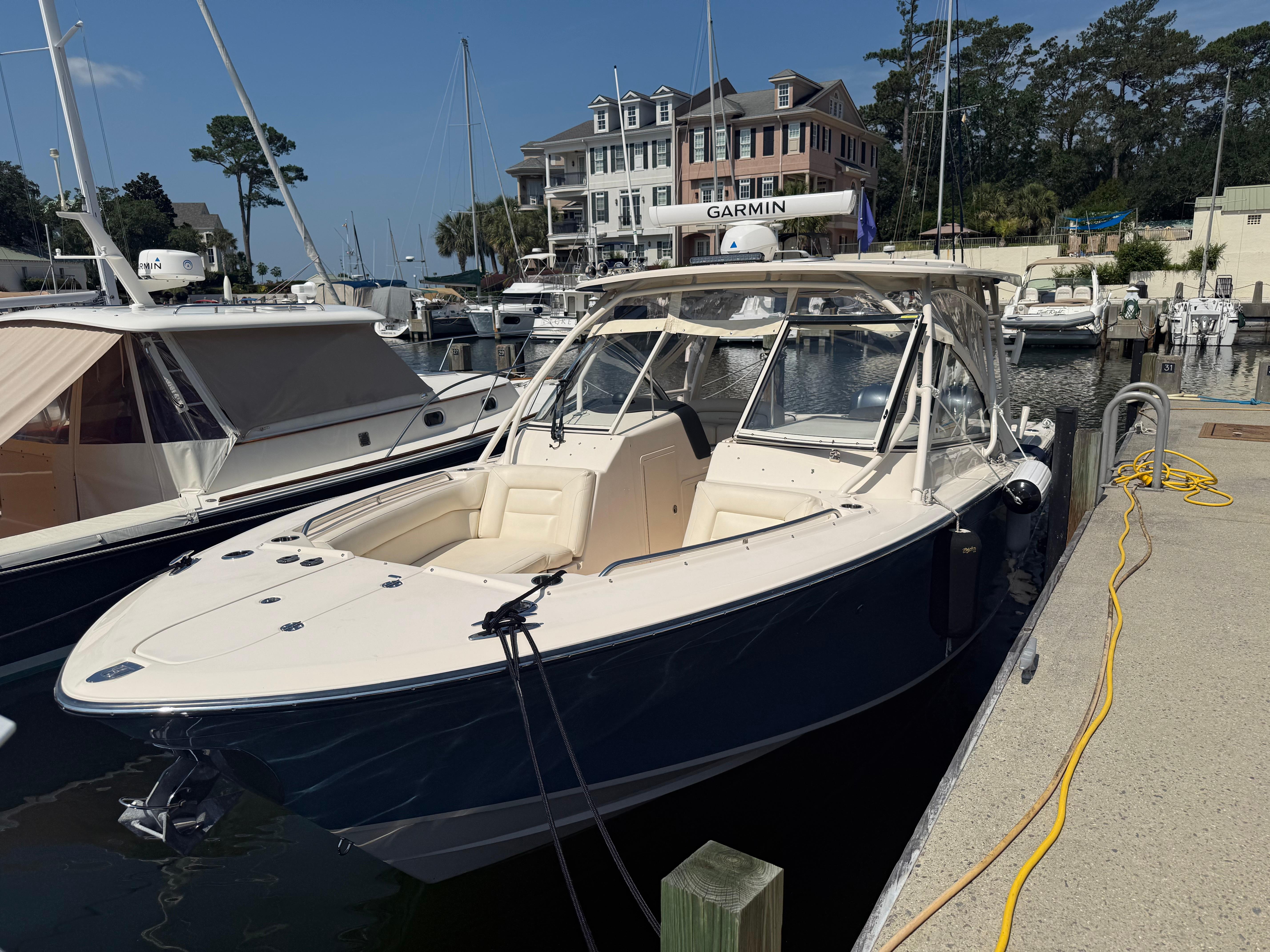 Grady-White Freedom 307 2021 Grady-White Freedom 307 boat docked at marina with nearby buildings.