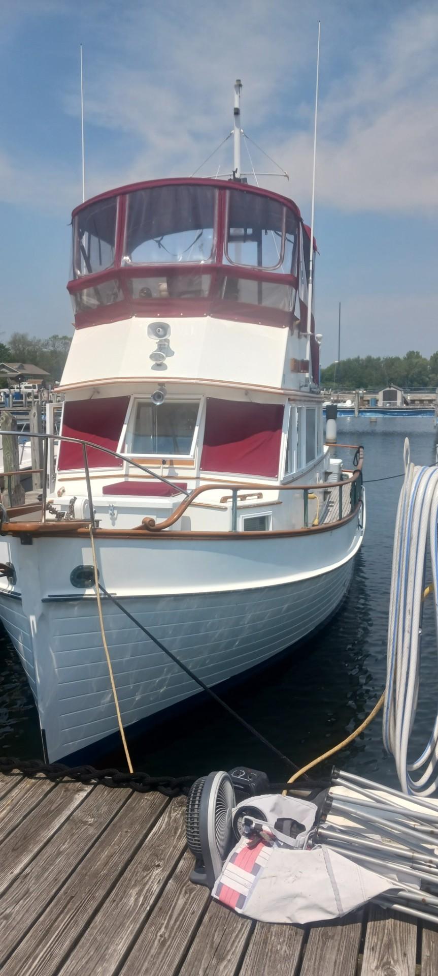 Grand Banks Classic 1977 Grand Banks Classic boat docked at marina under clear sky.