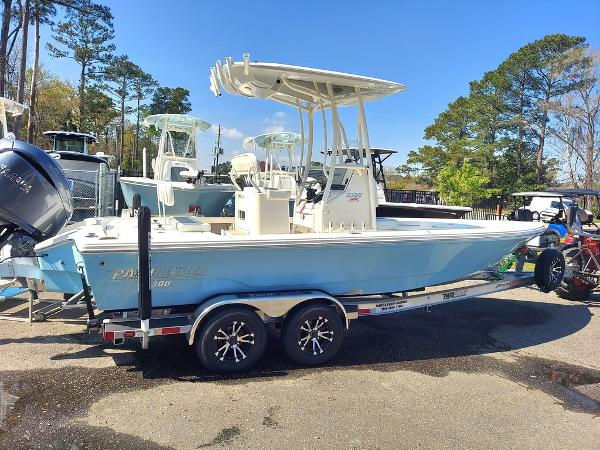 Pathfinder 2300 HPS 2023 Pathfinder 2300 HPS boat on trailer, light blue hull, parked outdoors.