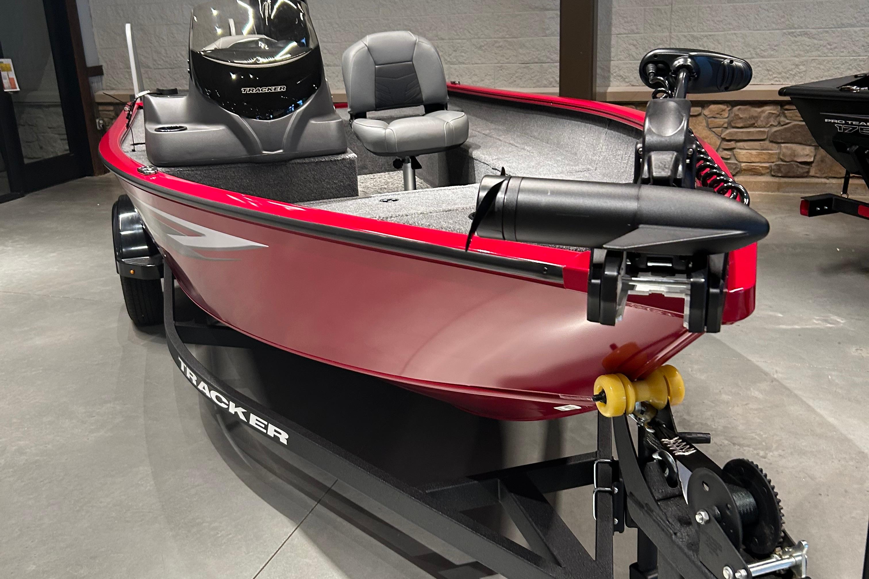 Tracker Super Guide V-16 T 2025 Tracker Super Guide V-16 T boat in showroom, red exterior, on trailer.