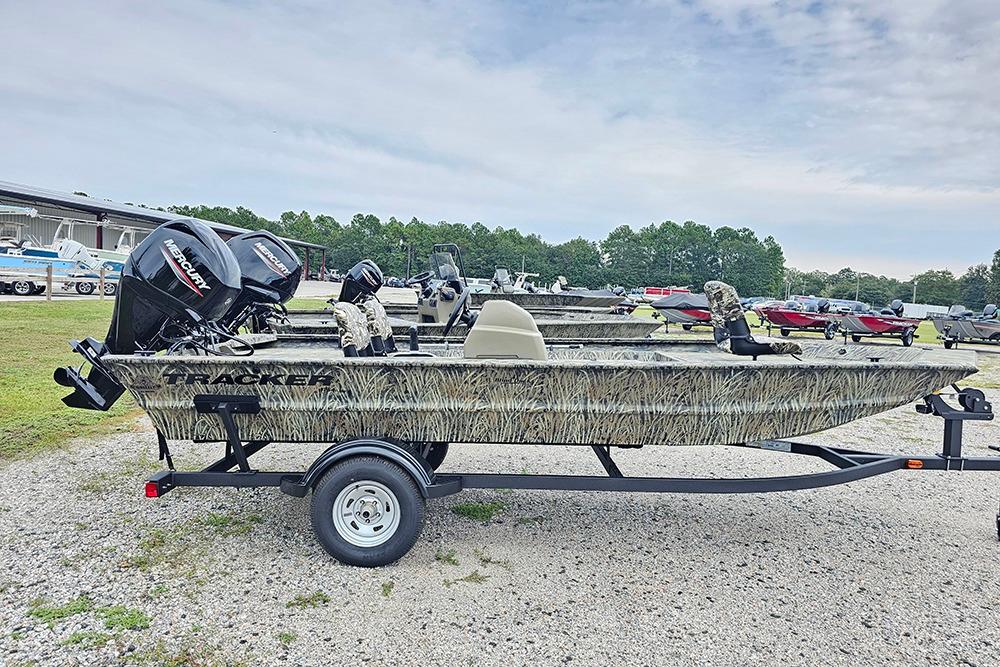 Tracker Grizzly 1754 SC 2026 Tracker Grizzly 1754 SC boat on trailer, camo design, parked outdoors.
