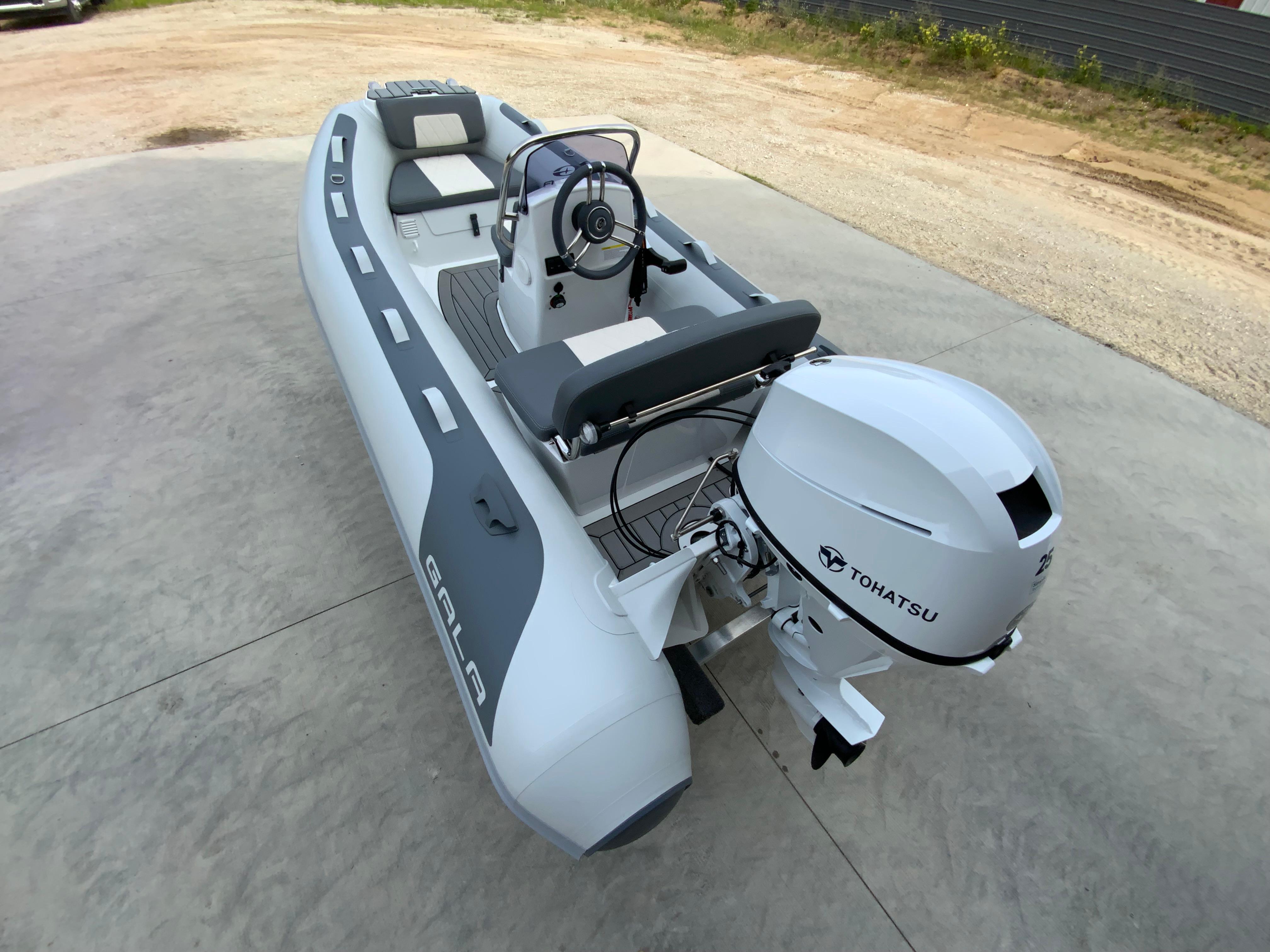 Gala A330L 2026 Gala A330L inflatable boat with Tohatsu outboard motor on concrete surface.