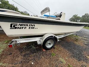 Carolina Skiff E18 JVX CC 2025 Carolina Skiff E18 JVX CC boat on trailer, parked outdoors.