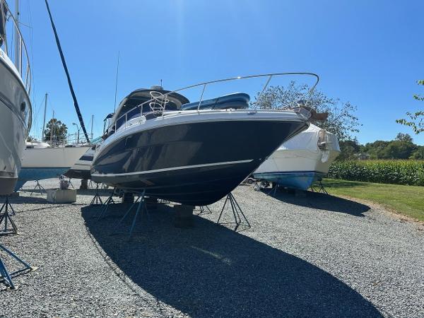 Sea Ray 340 Sundancer 2005 Sea Ray 340 Sundancer boat on stands in a gravel lot.