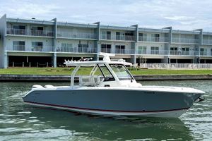 Pursuit S 328 Sport 2020 Pursuit S 328 Sport boat docked near waterfront apartments.