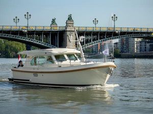 Linssen Grand Sturdy 30.0 Sedan 2019 Linssen Grand Sturdy 30.0 Sedan cruising under ornate bridge on a sunny day.