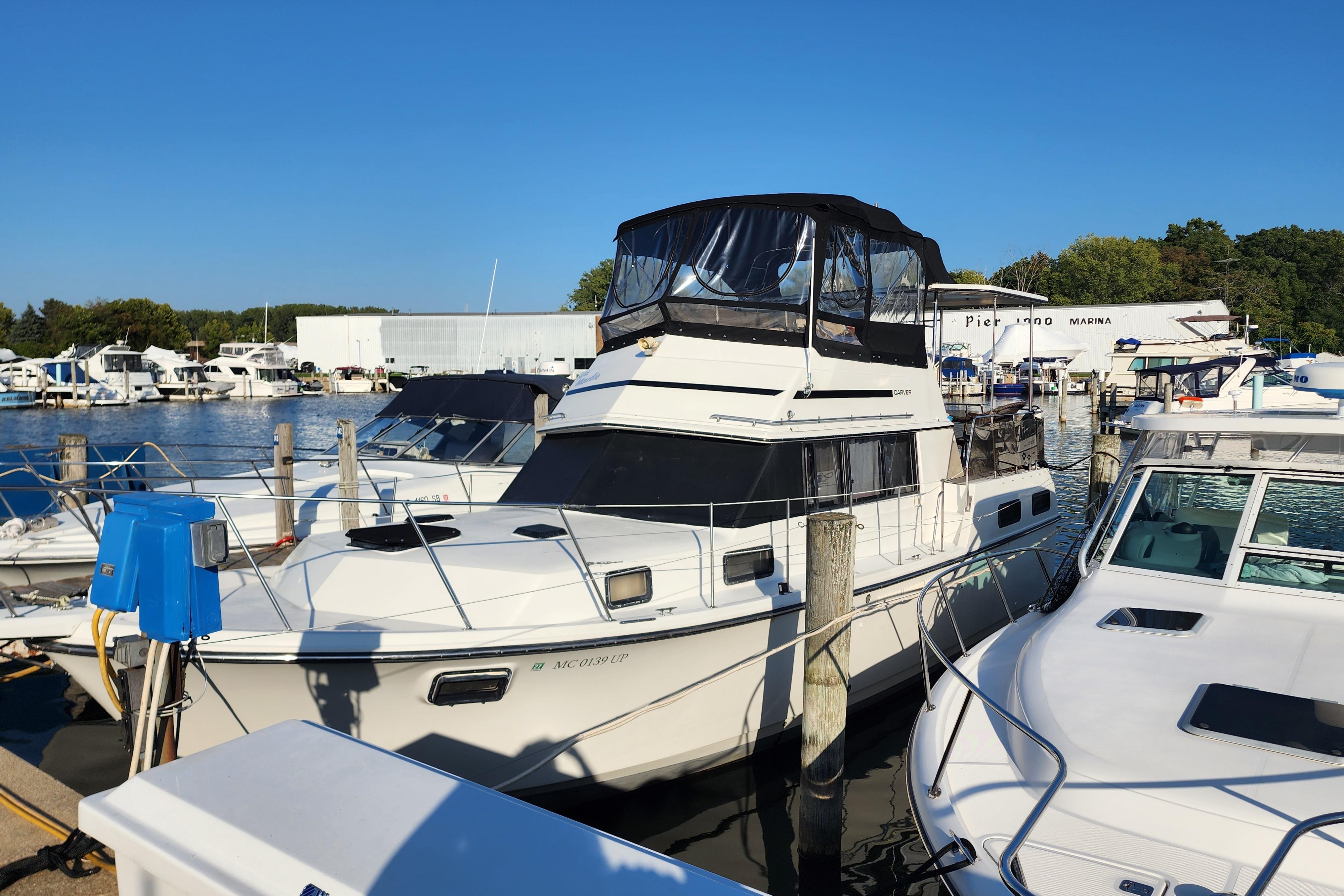 Carver 3607 Aft Cabin Motor Yacht 1989 Carver 3607 Aft Cabin Motor Yacht docked at marina under clear blue sky.