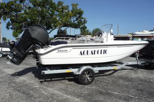 Boston Whaler 180 Dauntless 2007 Boston Whaler 180 Dauntless boat on trailer, labeled "AQUAHOLIC," parked outdoors.