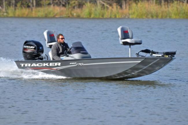 Tracker Pro 170 2017 Tracker Pro 170 boat speeding on a lake with a Mercury engine.