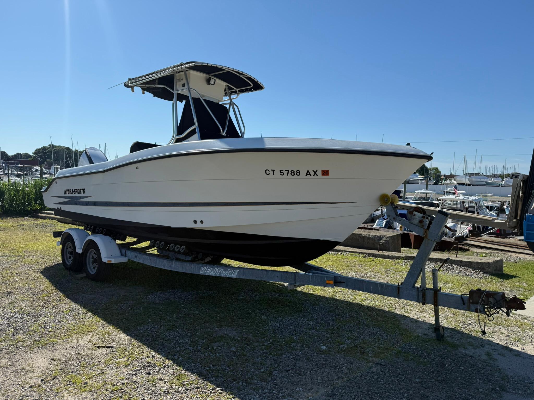 Hydra-Sports 2390 CC Vector 2001 Hydra-Sports 2390 CC Vector boat on trailer, parked outdoors under clear sky.
