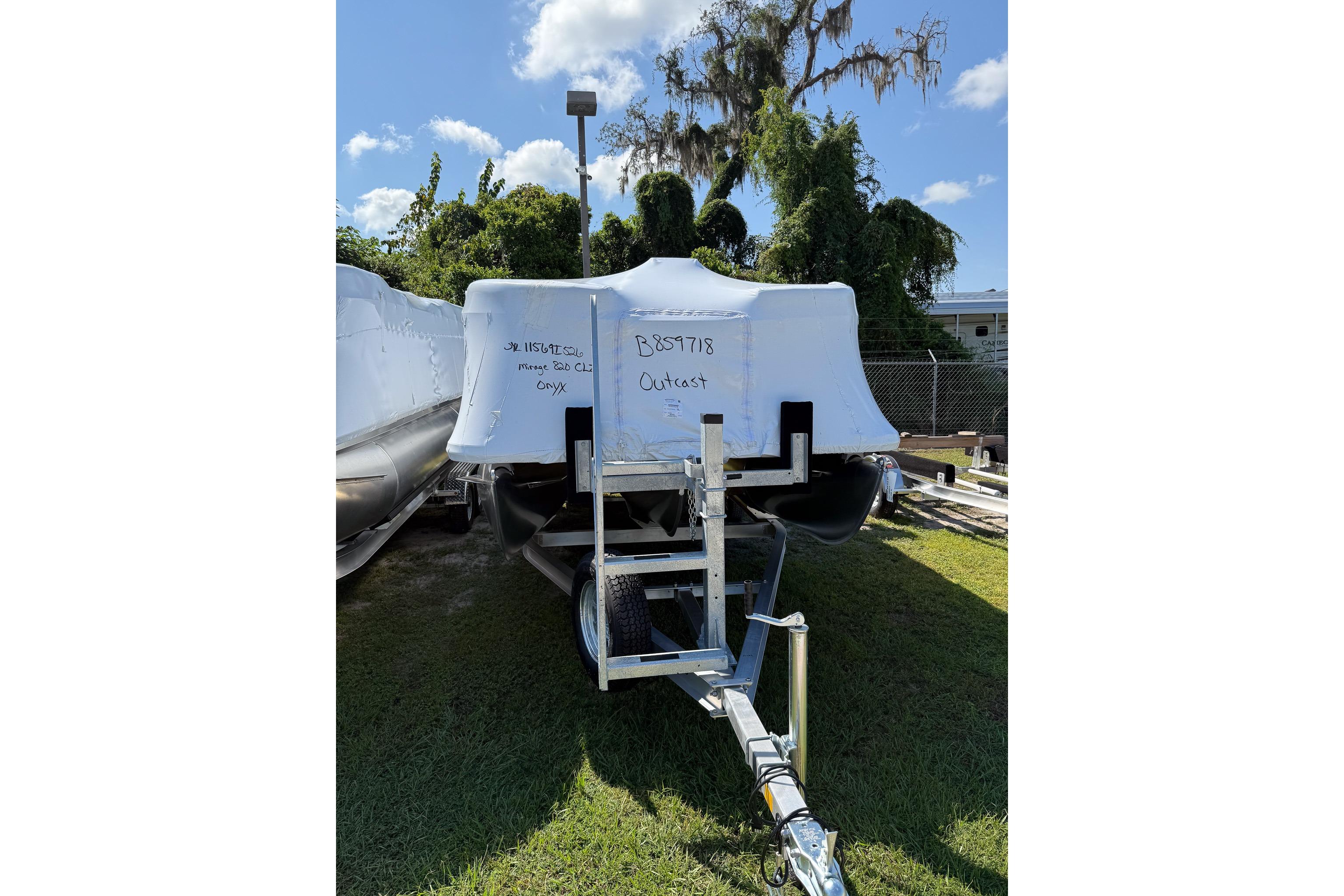 Sylvan Mirage 820 CLZ DH 2026 Sylvan Mirage 820 CLZ DH boat covered on a trailer, parked on grass.