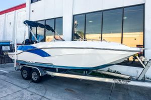 Starcraft SVX 231 OB DH 2022 Starcraft SVX 231 OB DH boat on trailer outside a building.