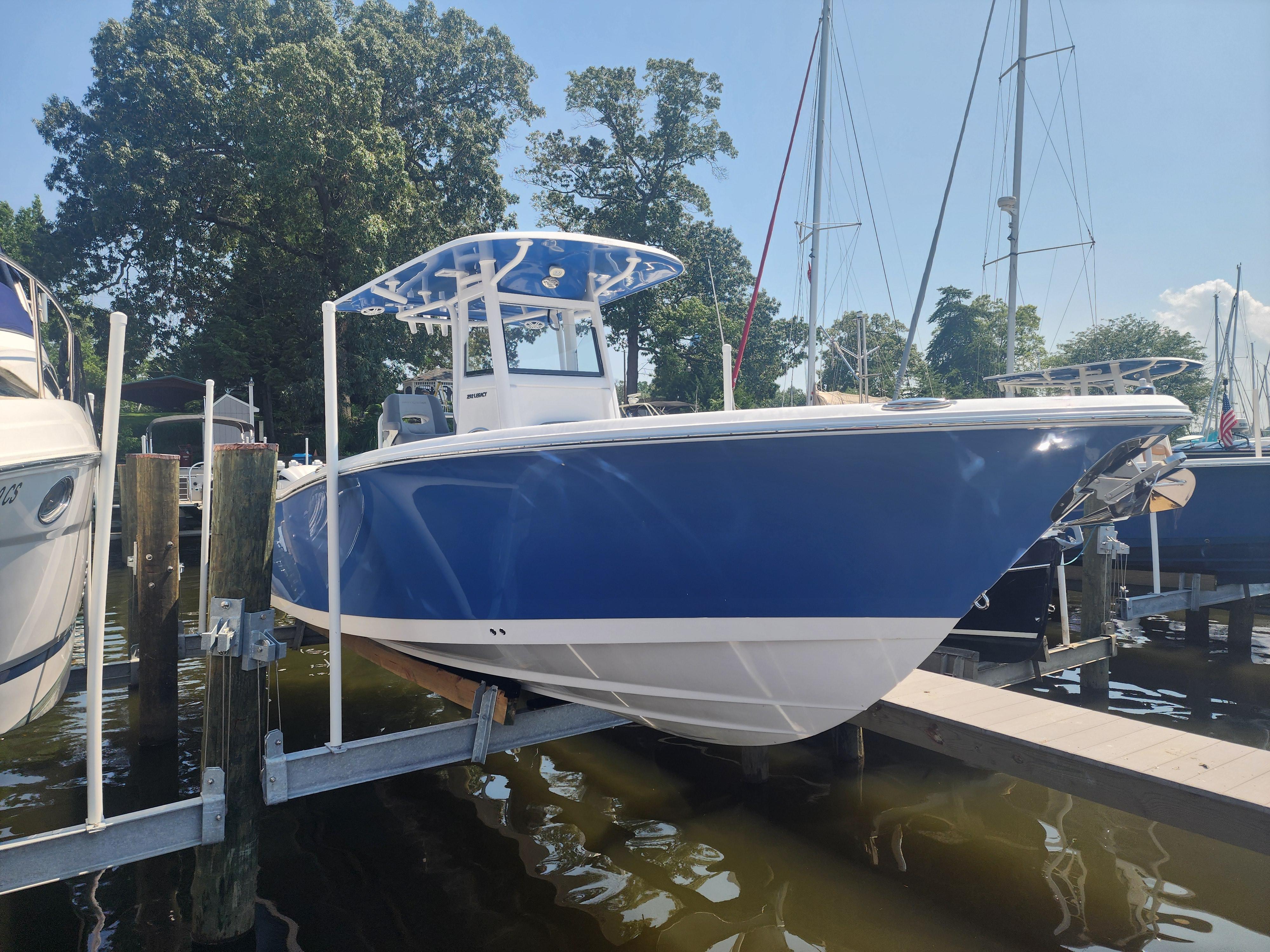 NauticStar 292 Legacy 2025 NauticStar 292 Legacy boat docked, featuring a sleek blue hull and modern design.