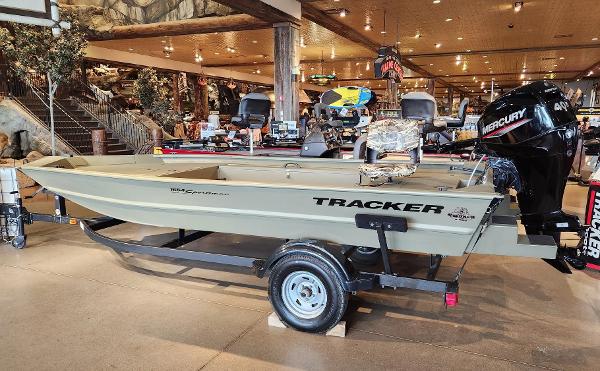 Tracker Grizzly 1654 T Sportsman 2024 Tracker Grizzly 1654 T Sportsman boat on display with Mercury outboard motor.