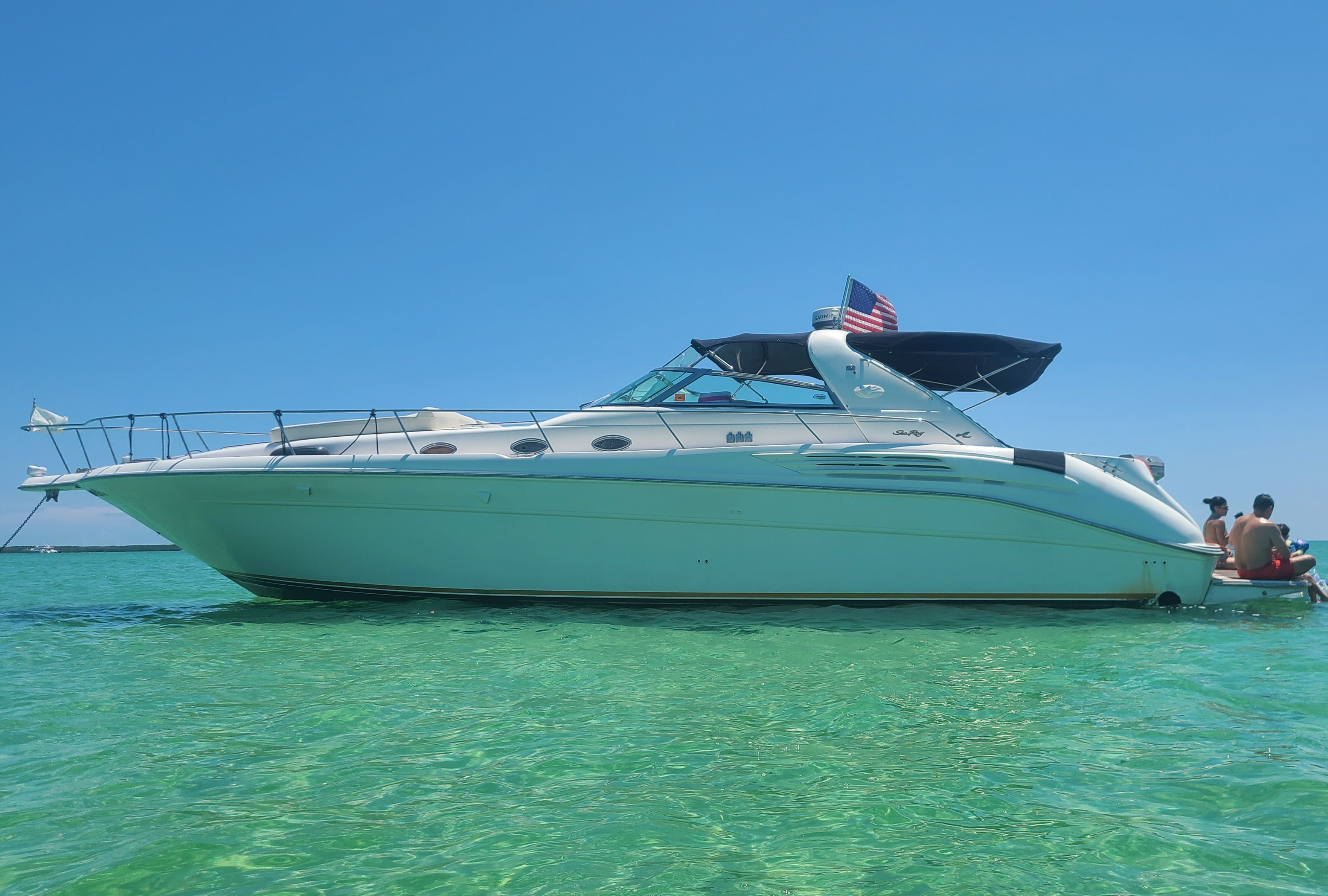 Sea Ray 450 1995 Sea Ray 450 yacht on clear turquoise water under a bright blue sky.