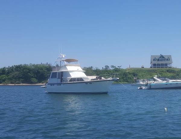 Chris-Craft 47 Commander Flush Deck 1973 Chris-Craft 47 Commander Flush Deck yacht anchored in a scenic bay.