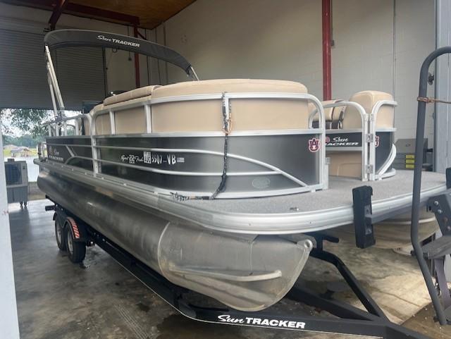 Tracker 22 DLX 2018 Tracker 22 DLX pontoon boat on trailer in a storage facility.