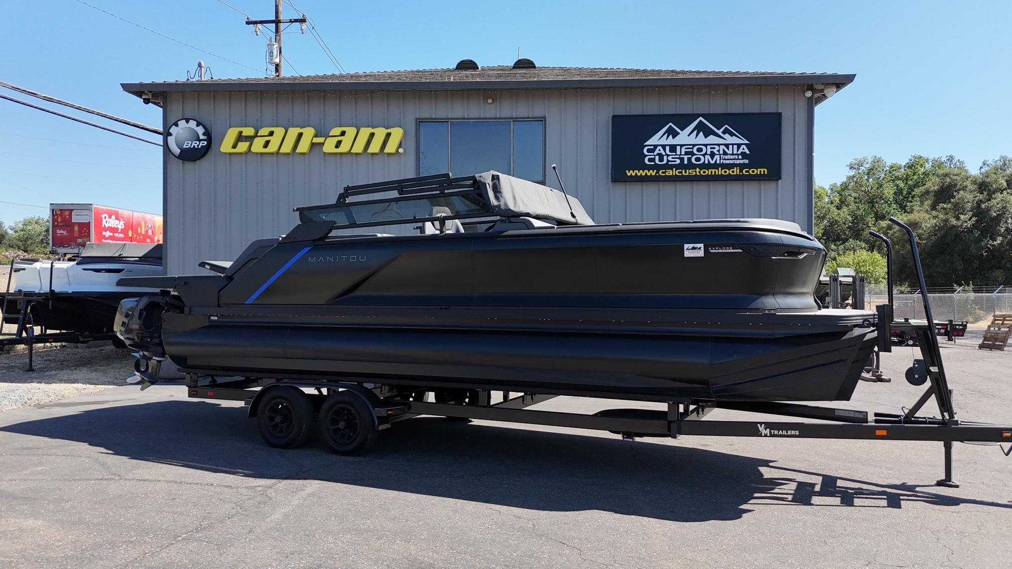 Manitou Explore Dual Engine 2025 Manitou Explore Dual Engine boat on trailer at California Custom dealership.