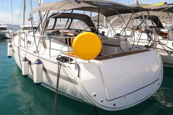 Bavaria 45 Cruiser 2013 Bavaria 45 Cruiser yacht docked in a marina, featuring a spacious deck and canopy.