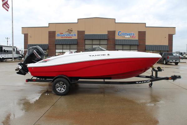 Tahoe T18 2025 Tahoe T18 boat on trailer, red and white, parked outside dealership.