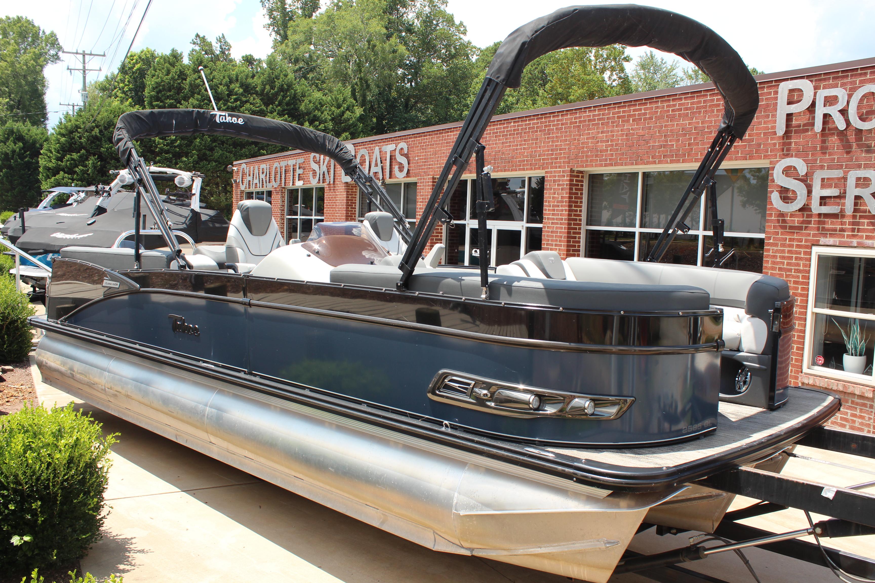 Tahoe CASCADE 2023 Tahoe CASCADE pontoon boat displayed outside a brick building.