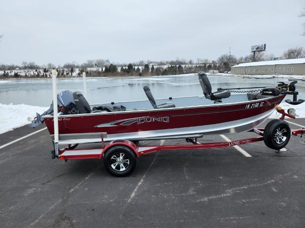 Lund 1600 Fury Tiller 2019 Lund 1600 Fury Tiller boat on trailer by a snowy lake.