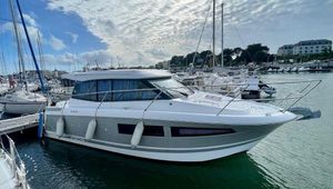 Jeanneau NC9 2013 Jeanneau NC9 yacht docked in a marina under a partly cloudy sky.