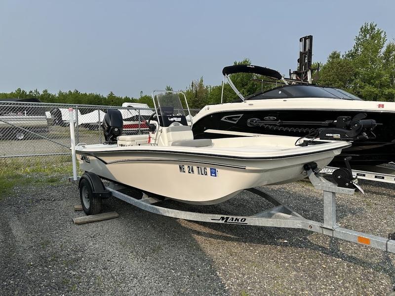 Mako Pro Skiff 15 CC 2022 Mako Pro Skiff 15 CC on trailer, parked outdoors near other boats.