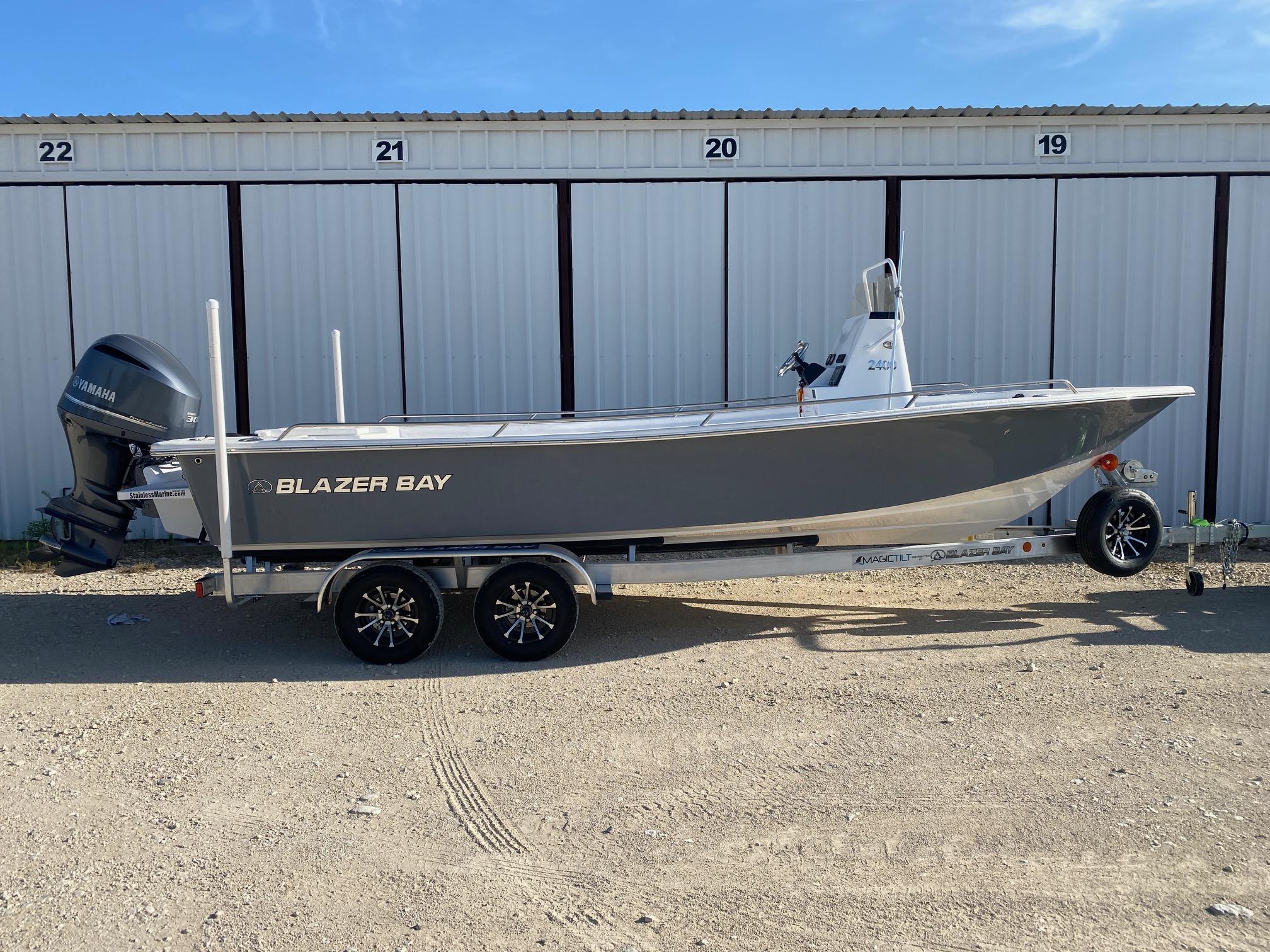 Blazer Bay 2400 Open Bay Striper 2025 Blazer Bay 2400 Open Bay Striper boat on trailer, parked outdoors.