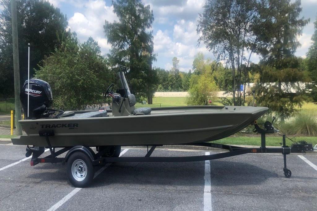 Tracker Grizzly 1860 CC 2026 Tracker Grizzly 1860 CC boat on trailer, parked outdoors under cloudy sky.