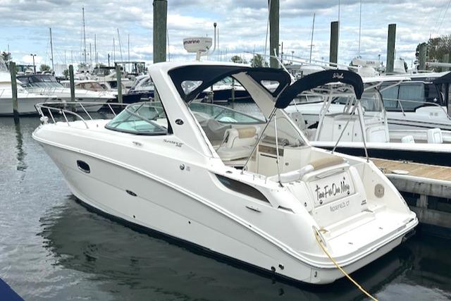 Sea Ray 310 Sundancer 2010 Sea Ray 310 Sundancer boat docked at marina, featuring sleek white design.