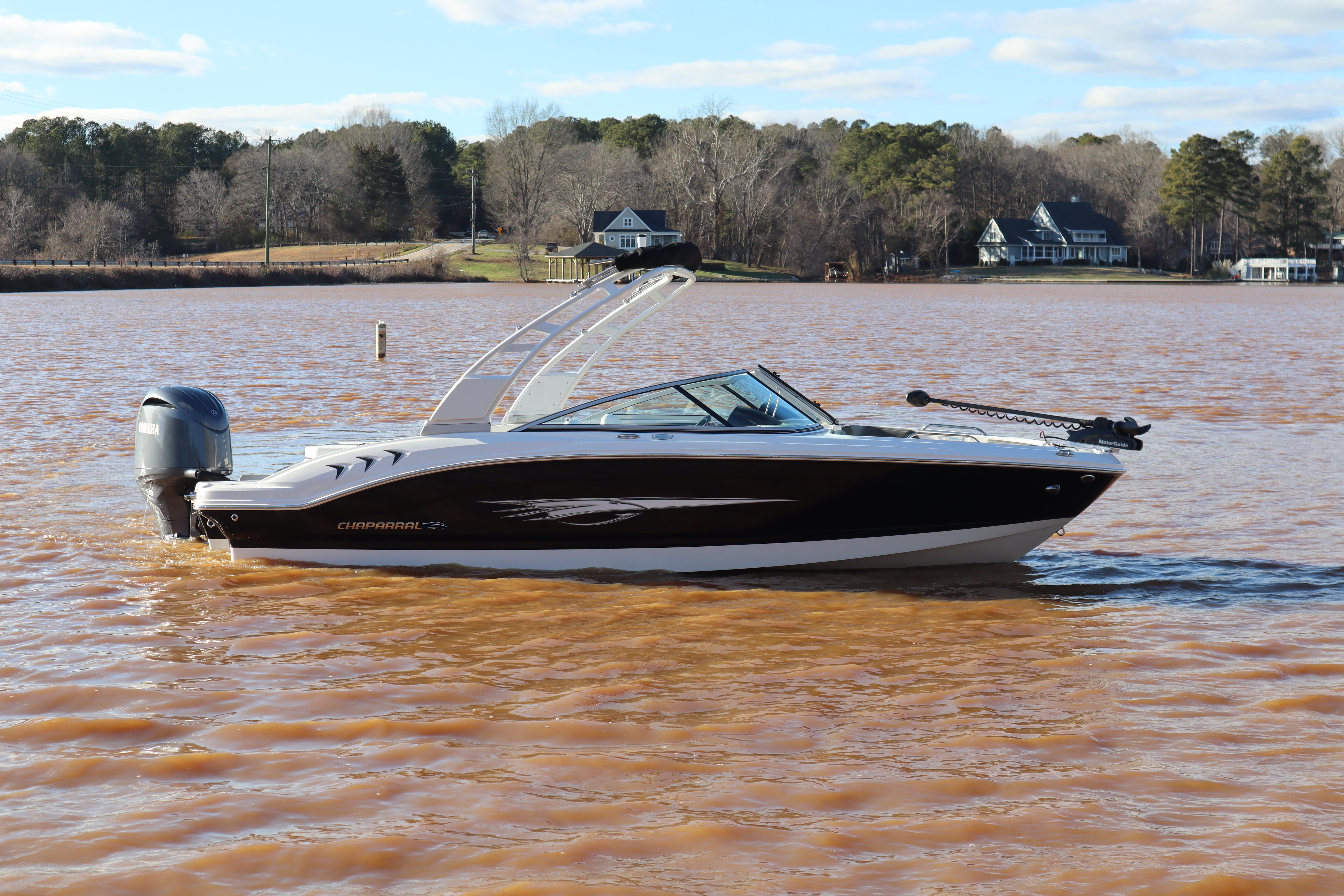 Chaparral 21 SSi Ski & Fish OB 2024 Chaparral 21 SSi Ski & Fish OB boat on a lake with scenic background.