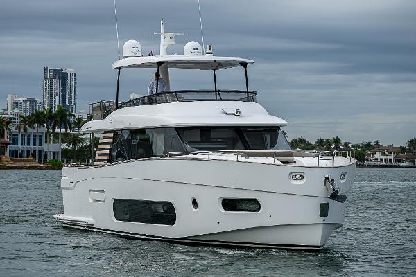 Azimut Magellano 66 2024 Azimut Magellano 66 yacht cruising near city skyline.
