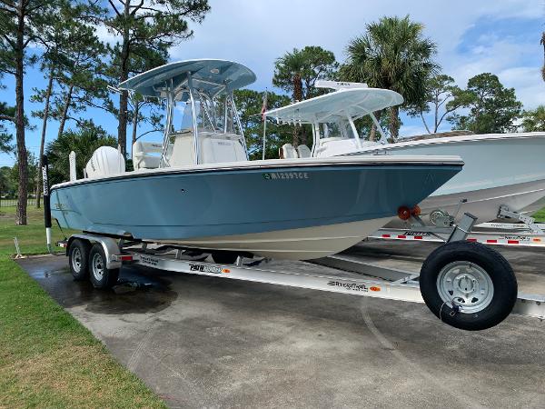 Pathfinder 2400 TRS 2024 Pathfinder 2400 TRS boat on trailer, parked outdoors with trees in background.