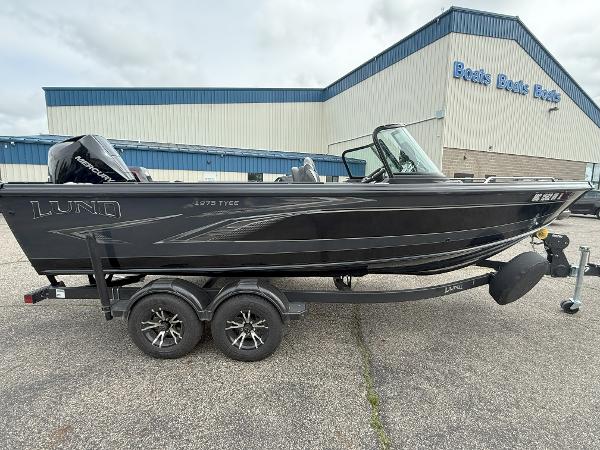 Lund 1975 Tyee Lund 1975 Tyee 2022 boat on trailer outside dealership.