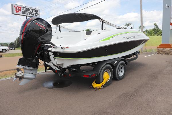 Tahoe 1950 Tahoe 1950 boat on trailer, parked near Tractor Supply Co, 2022 model.