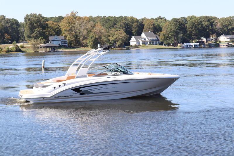 Chaparral 23 SSi 2024 Chaparral 23 SSi boat cruising on a serene lake with houses in the background.