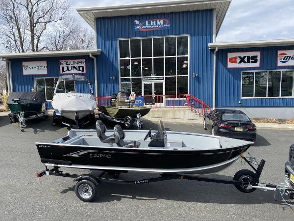 Lund 1600 Fury 2025 Lund 1600 Fury SS boat on trailer outside dealership.