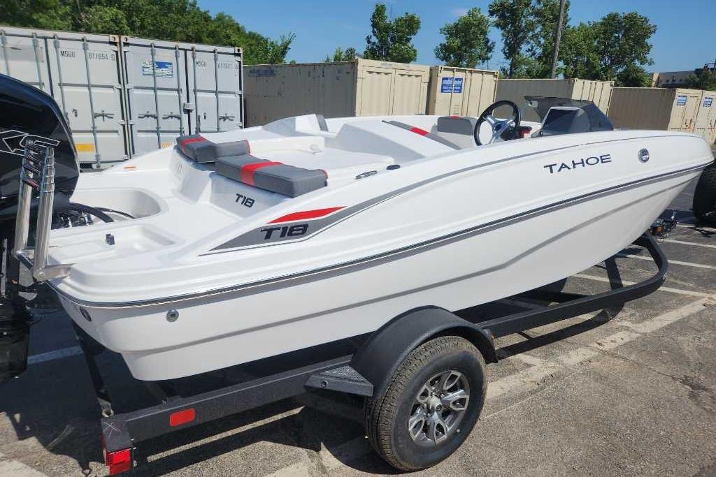 Tahoe T18 2025 Tahoe T18 boat on trailer, white with red accents, parked outdoors.