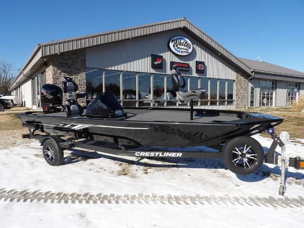 Crestliner XF 189 2025 Crestliner XF 189 boat on trailer outside dealership in snowy setting.
