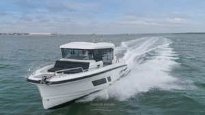 Quarken 27 Cabin 2022 Quarken 27 Cabin boat cruising on open water, creating a dynamic wake.