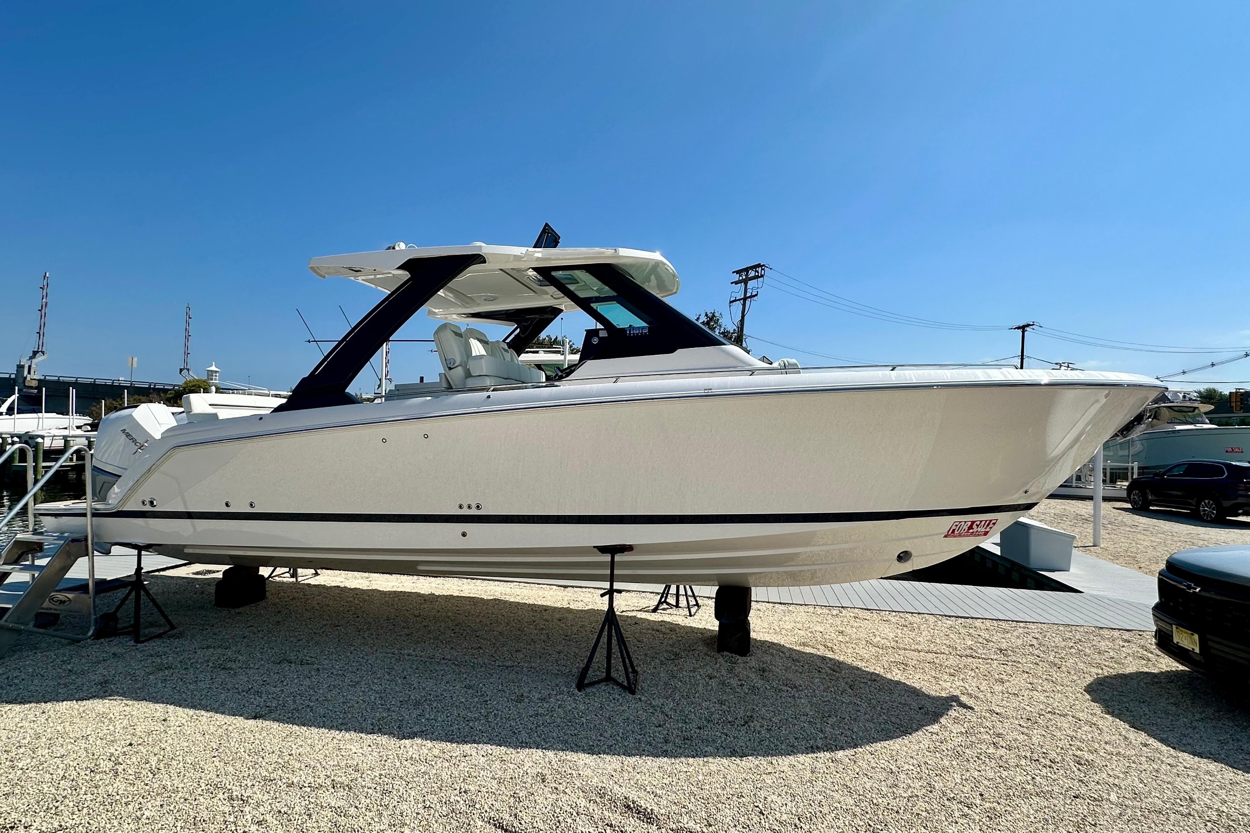 Tiara Yachts 34 LS 2026 Tiara Yachts 34 LS, sleek white design, displayed outdoors under clear blue sky.