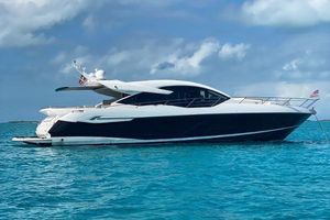 Sunseeker Predator 74 XPS 2020 Sunseeker Predator 74 XPS yacht on turquoise water under a cloudy sky.