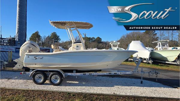 Scout 195 Sportfish 2025 Scout 195 Sportfish boat on trailer at authorized dealer, side view.